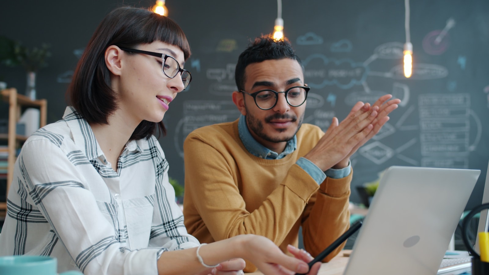Team reviewing information on a laptop